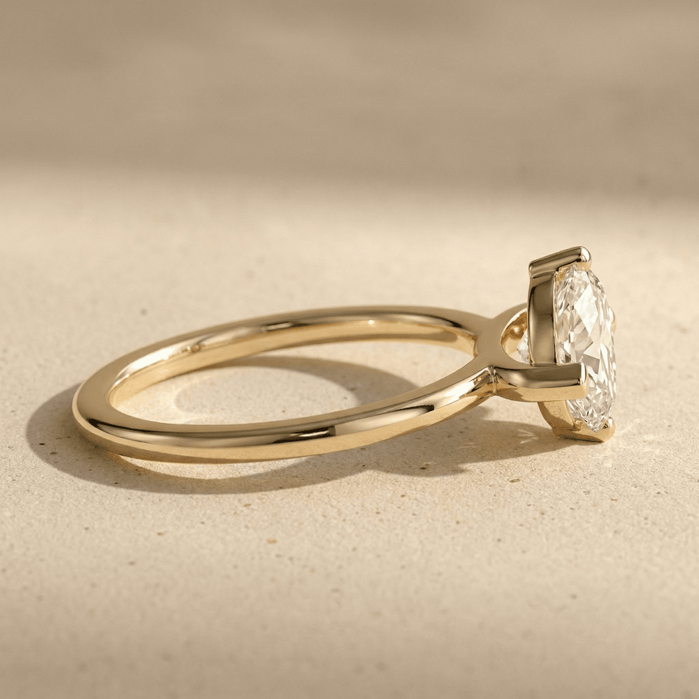 Dainty east west marquise engagement ring in yellow gold