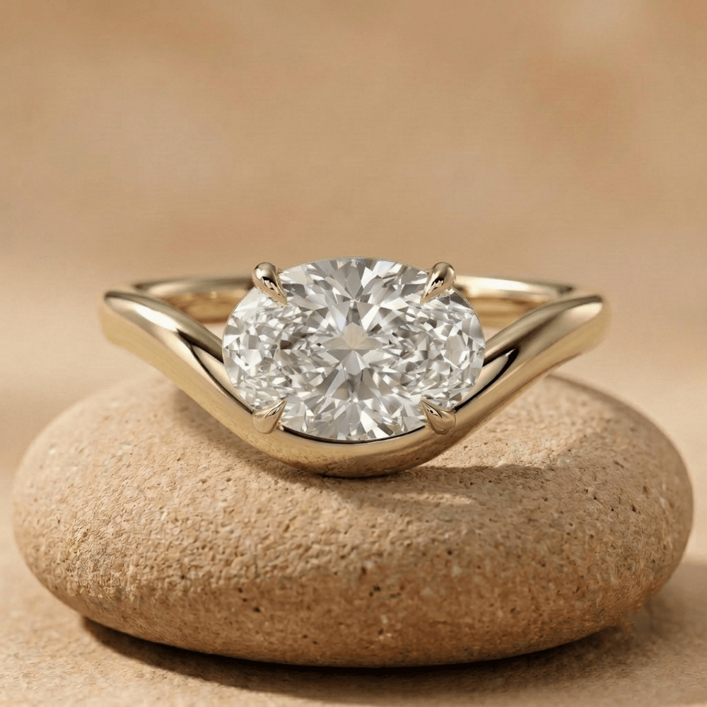 Oval east west moissanite ring in 14K yellow gold wave band