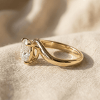 Side view of oval moissanite ring with curved 14K gold band