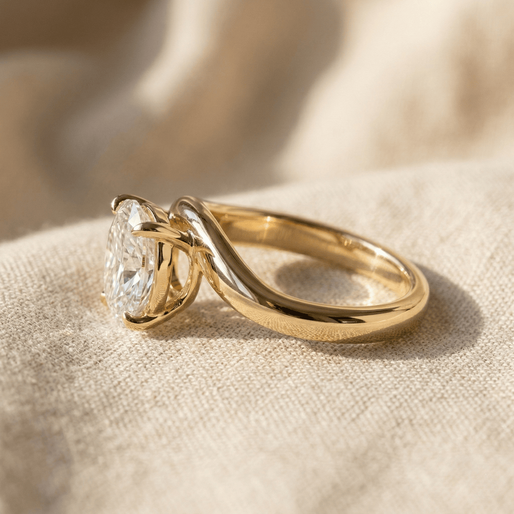 Side view of oval moissanite ring with curved 14K gold band