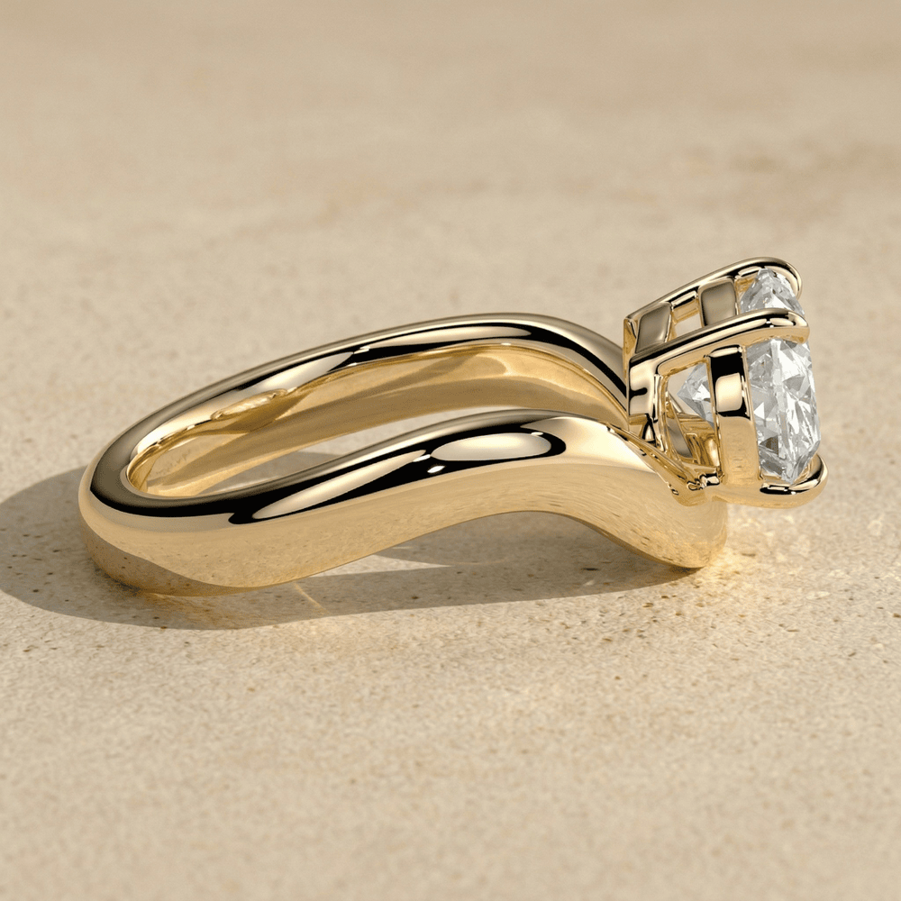 East west oval moissanite ring with yellow gold wave band, top view