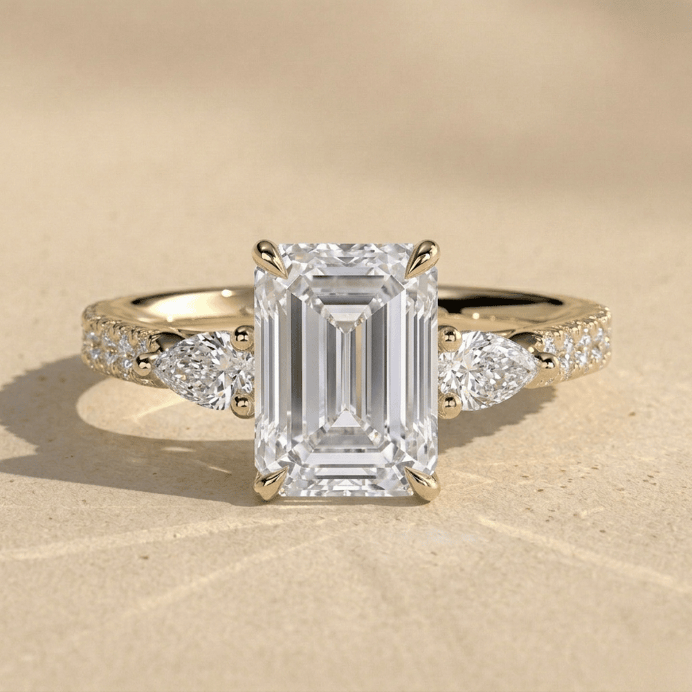 14K gold emerald three stone moissanite ring