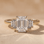 Three stone emerald moissanite ring with baguette accents