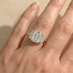 Three stone moissanite promise ring with emerald center stone