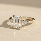 Emerald moissanite wedding ring with two side stones
