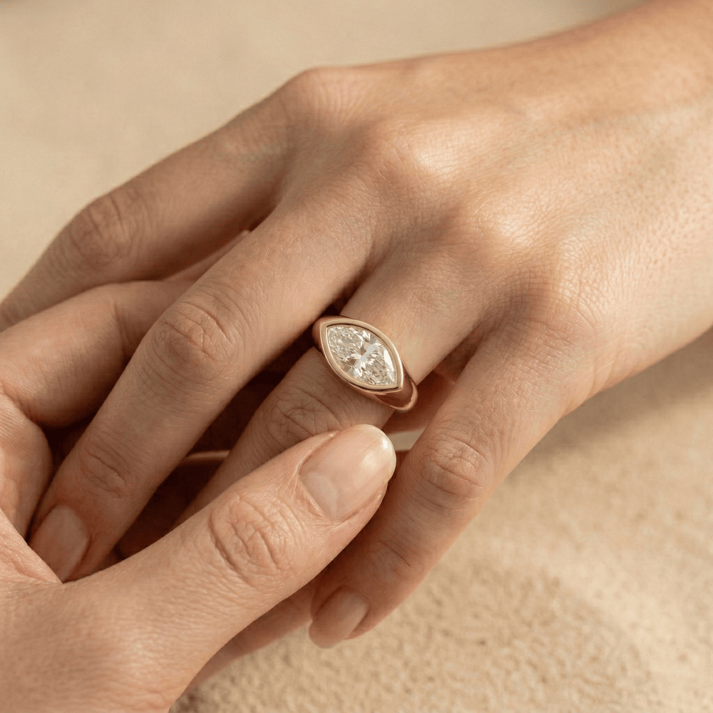 East west moissanite ring with smooth signet band
