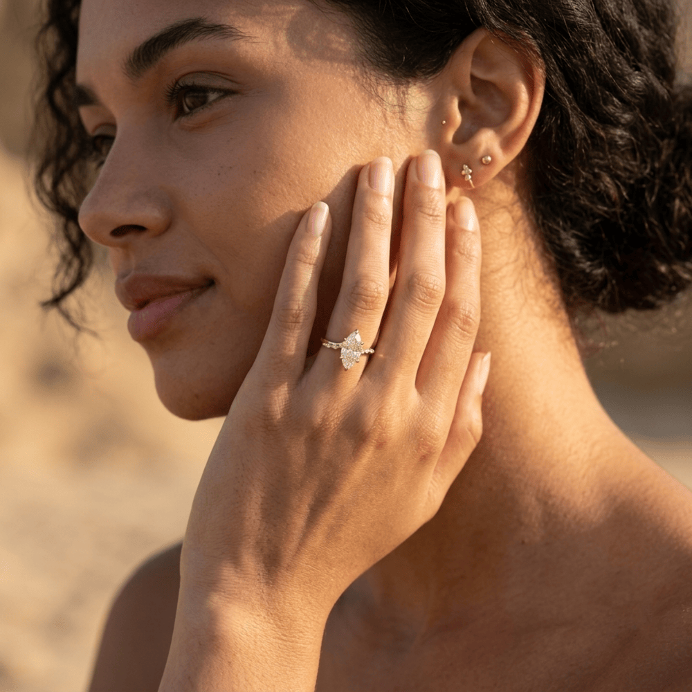 Yellow gold cathedral engagement ring with marquise center moissanite