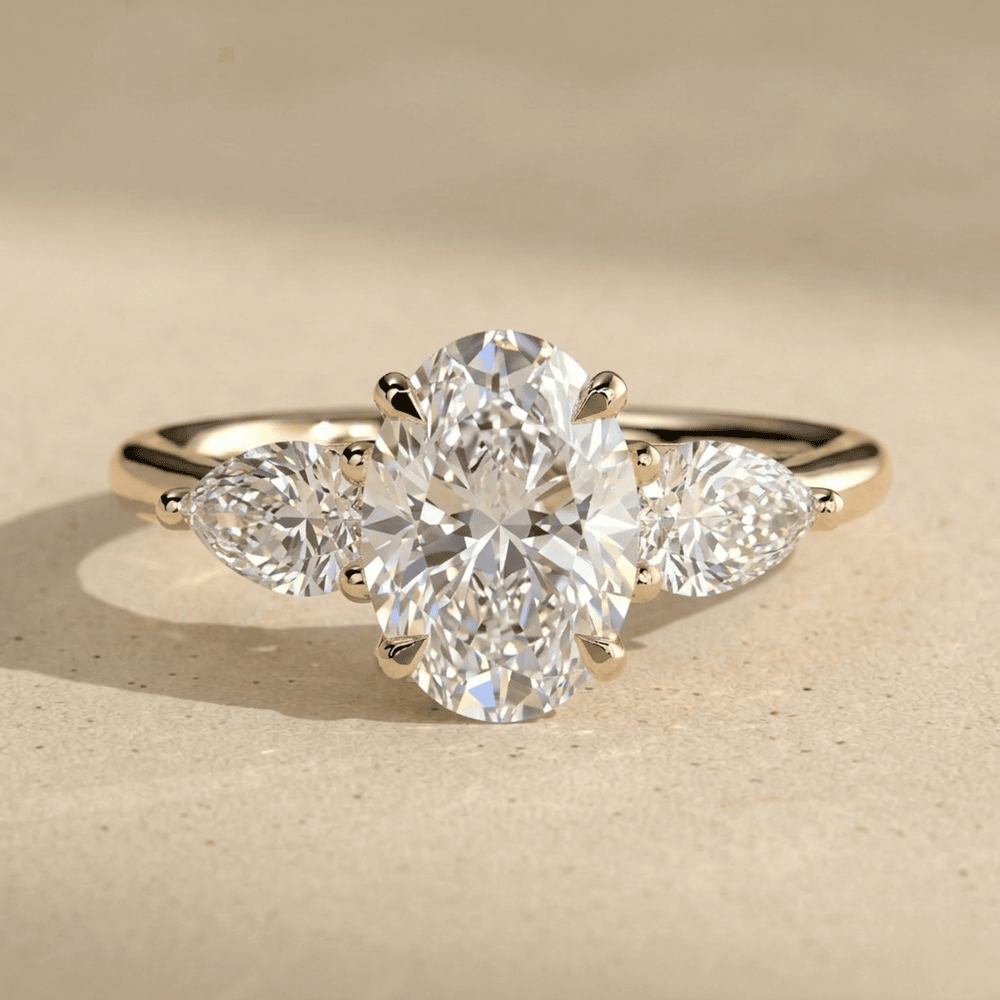 14K gold oval three stone moissanite ring