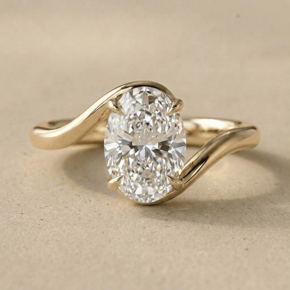 Oval cut moissanite ring in 14K gold bypass band