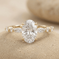 Oval moissanite engagement ring with delicate marquise band in 14K gold