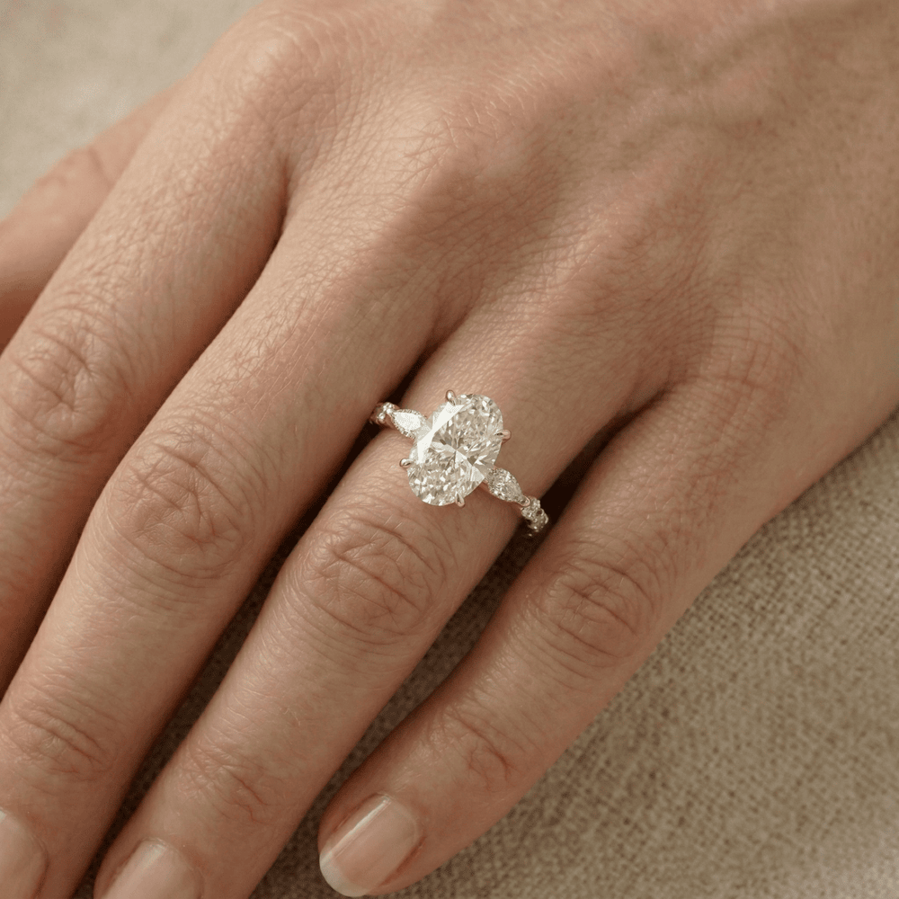 Oval solitaire wedding ring with brilliant side stones