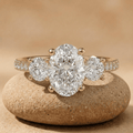Oval moissanite three stone engagement ring with 14K pavé band