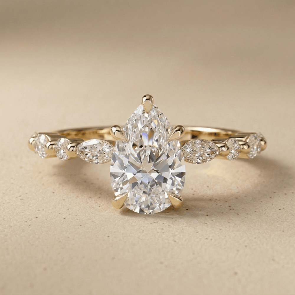 Pear shaped moissanite engagement ring in 14K gold