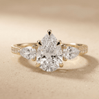 Pear moissanite ring with sparkling pavé band