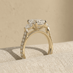 Three stone pear moissanite ring with elegant gold setting