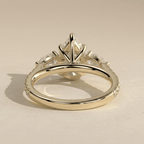 Pear cut moissanite engagement ring with side stones