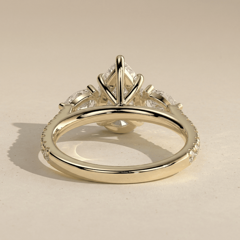 Pear cut moissanite engagement ring with side stones