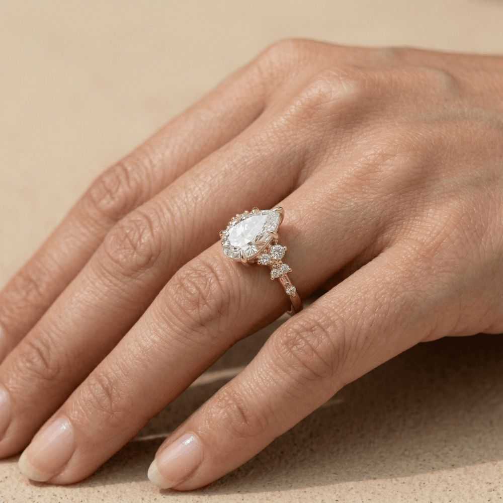 Gold pear shaped moissanite ring with detailed setting