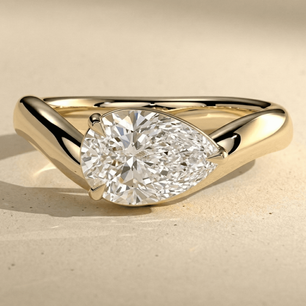 Pear shaped moissanite solitaire ring with wave band