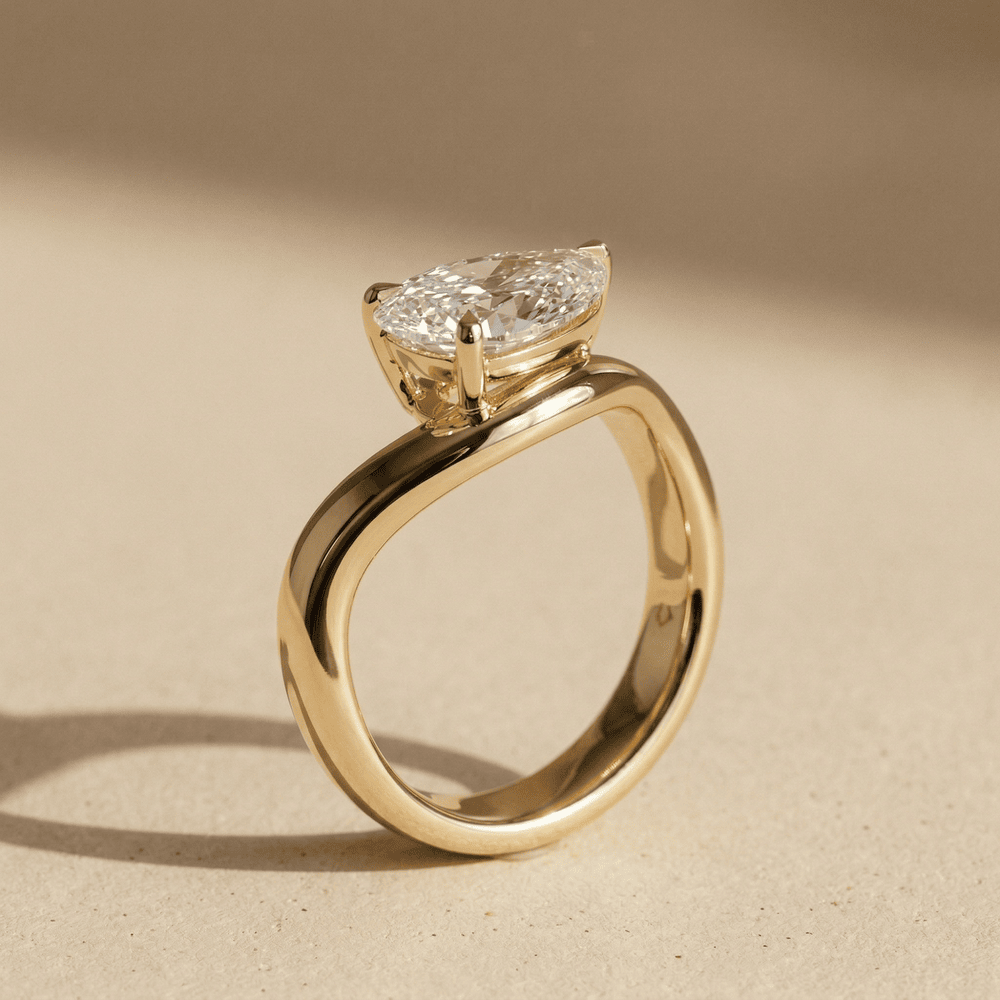Pear solitaire promise ring with curved gold band