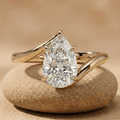 Pear cut moissanite solitaire bypass engagement ring in 18K yellow gold