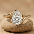 Pear cut moissanite solitaire bypass engagement ring in 18K yellow gold