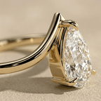 Curved wedding band with pear solitaire moissanite side view