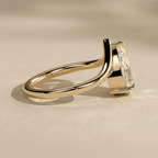Elegant pear cut moissanite bridal ring with curved band side angle