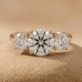 Round cut moissanite three stone engagement ring