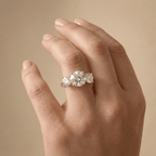 Three stone moissanite ring with brilliant round center