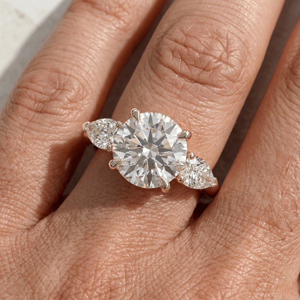 Round cut three stone moissanite bridal ring in 14K gold