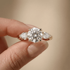 Three stone gold engagement ring with round moissanite